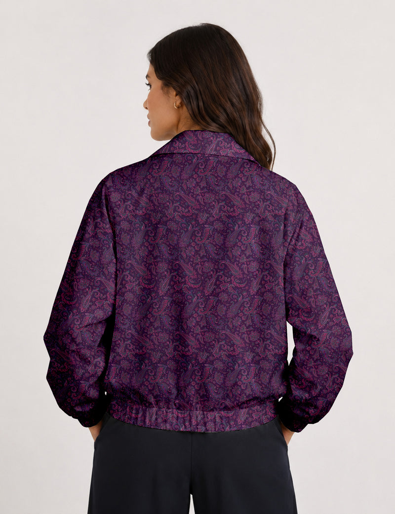 Woman wearing a yellow floral bomber jacket with front zipper, elastic cuffs, and side pockets, shown from front view
