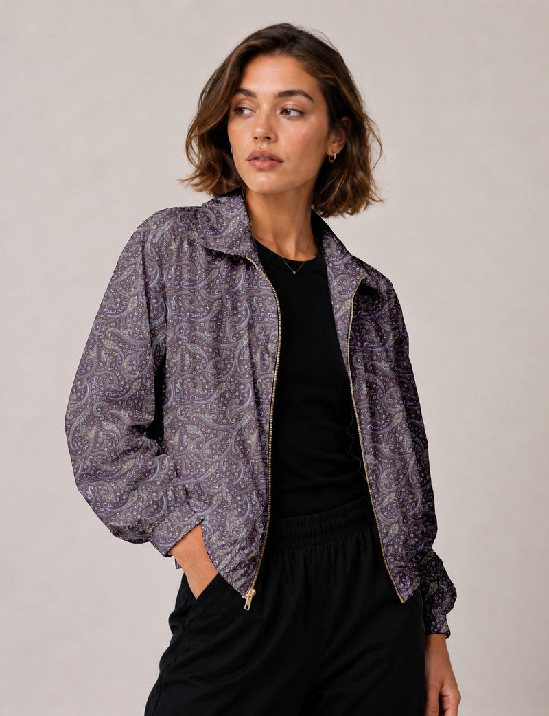 Brown floral bomber jacket with front zipper, elastic cuffs and hem, hanging on white hanger, red floral inner lining visible