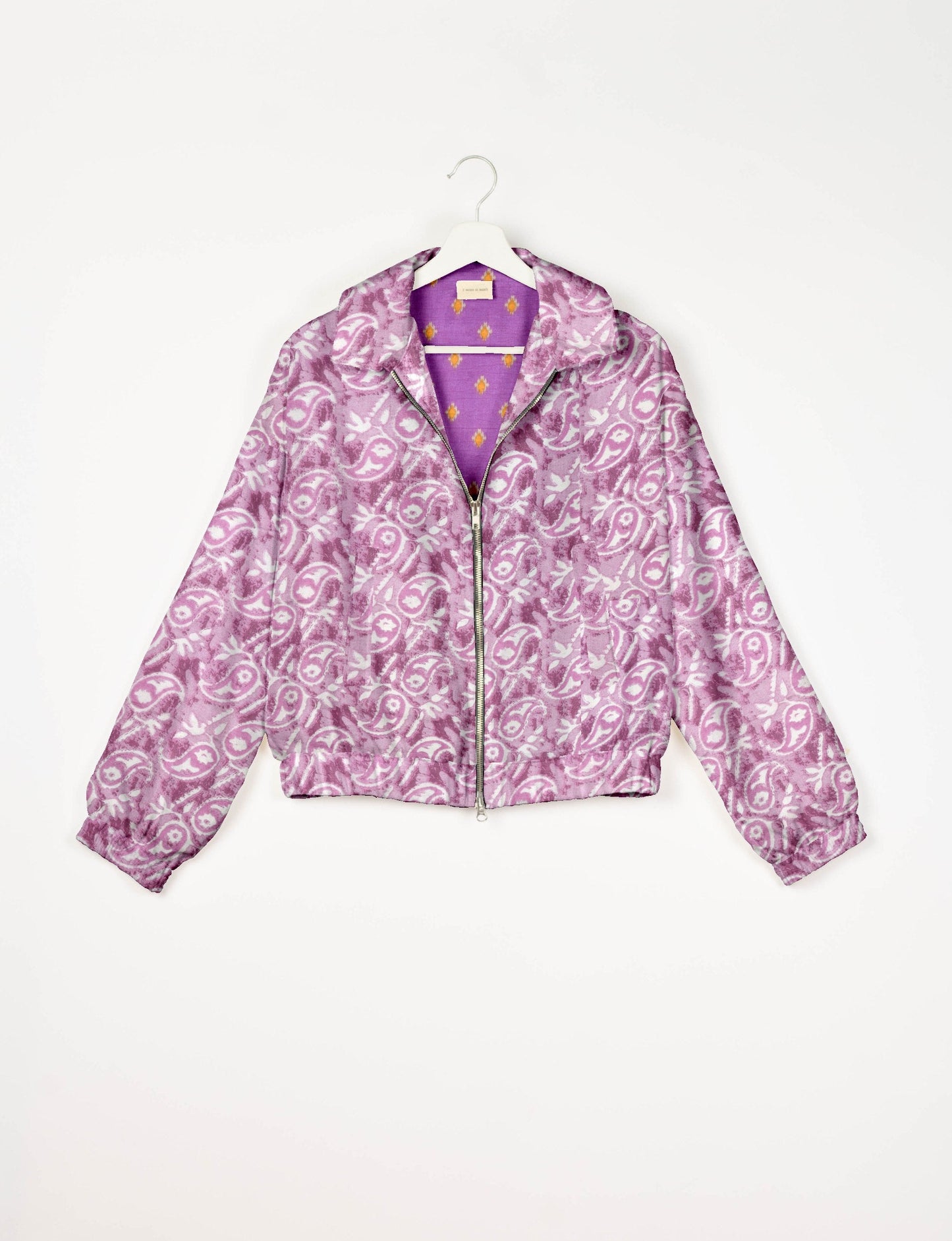 Upcycled Bomber Jacket made from recycled sari materials, featuring a cute cropped shape, elasticated hem and cuffs, and contrast sari print lining. Sustainable apparel promoting eco-friendly fashion and ethical clothing.