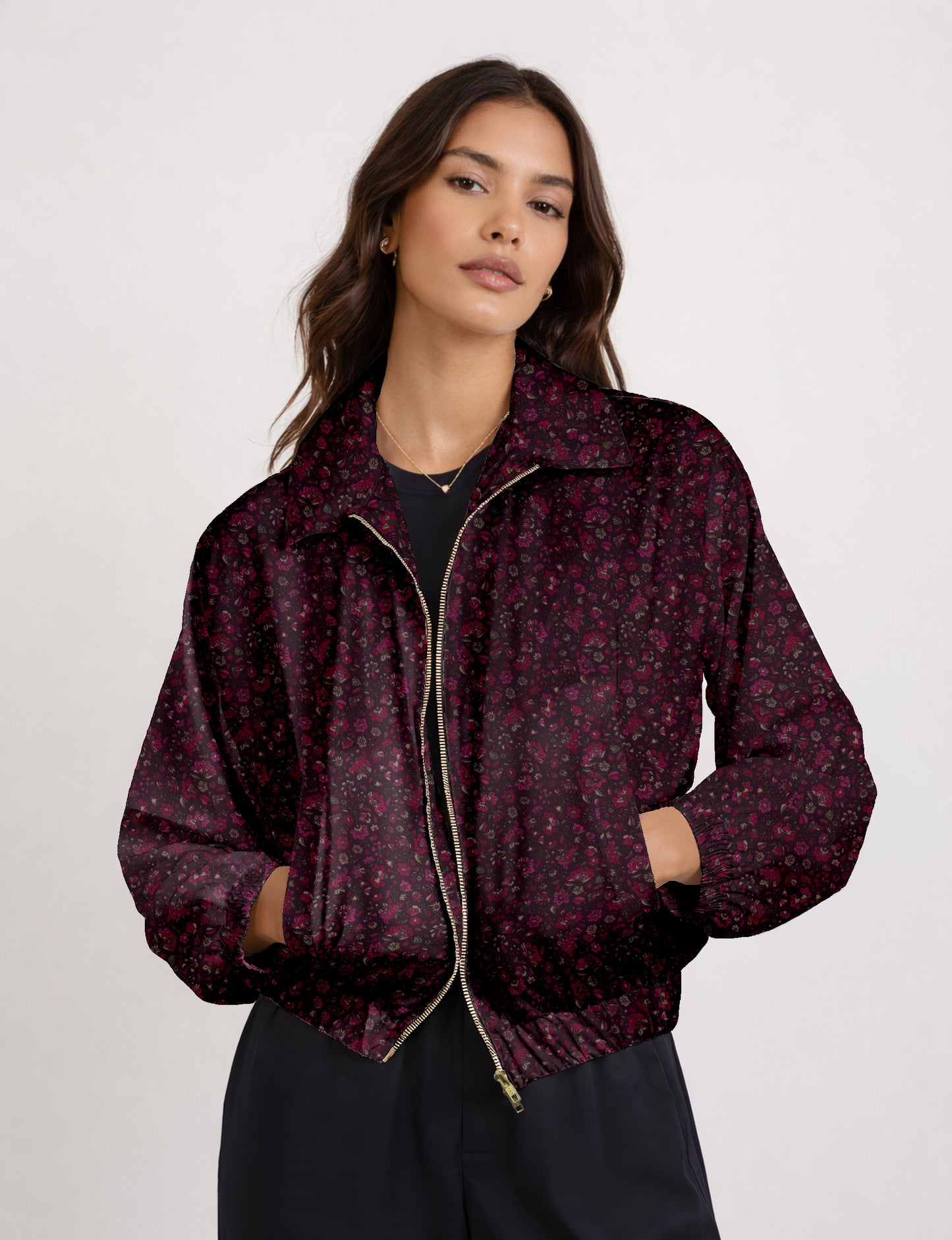 Women's cropped bomber jacket with twin metallic front zippers, welt pockets, elasticated hem and cuffs, and contrast sari print lining.