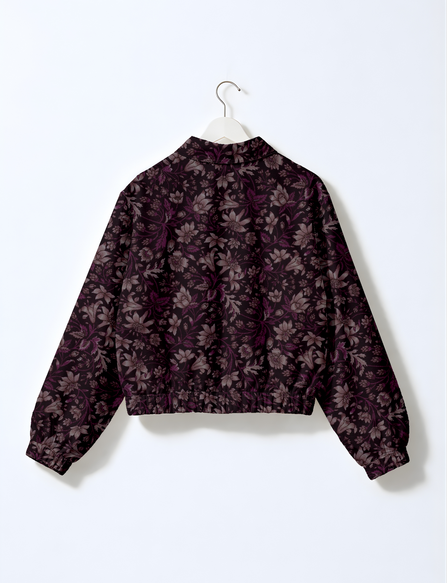 Women's cropped bomber jacket with twin metallic front zippers, welt pockets, elasticated hem and cuffs, and contrast sari print lining.