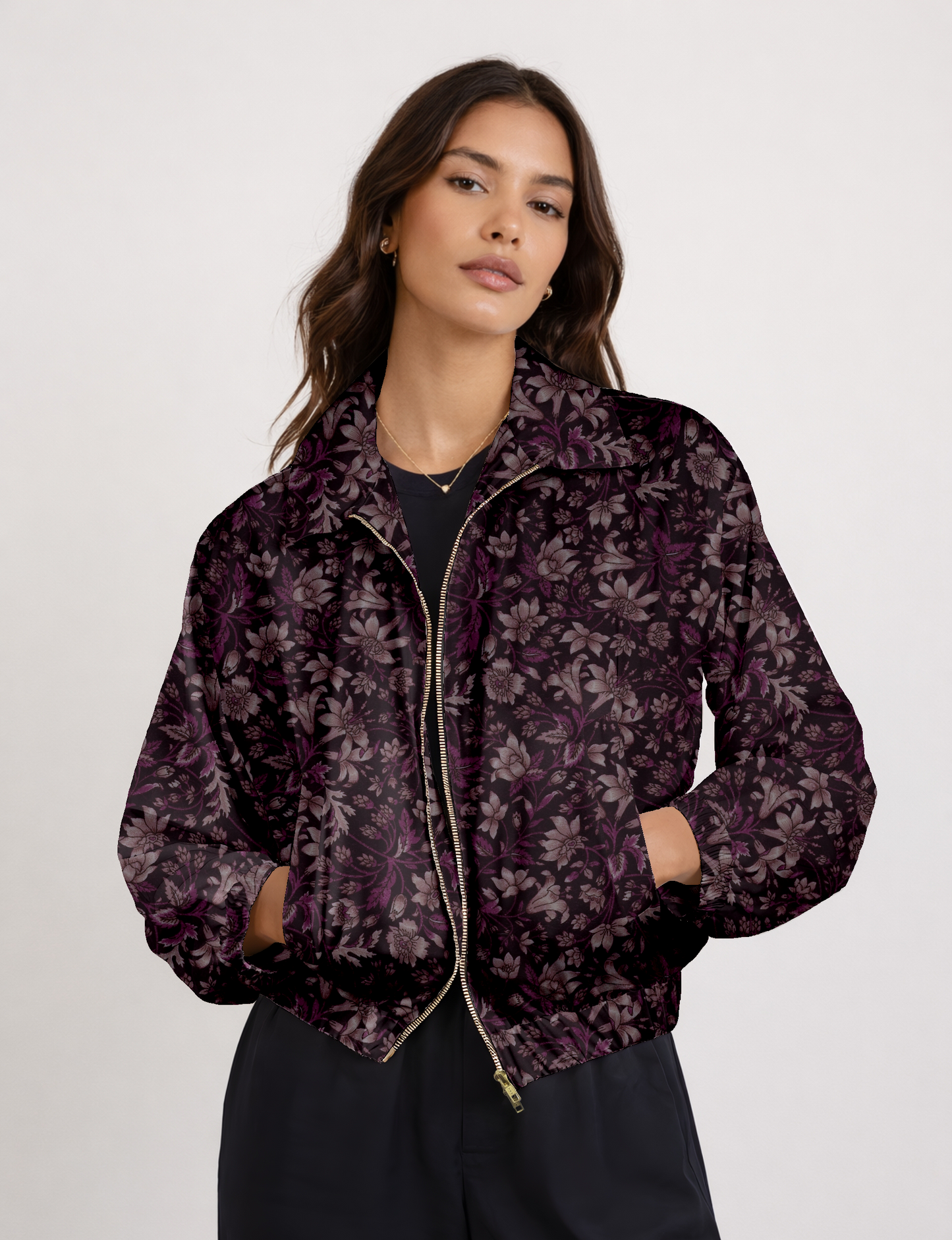 Women's cropped bomber jacket with twin metallic front zippers, welt pockets, elasticated hem and cuffs, and contrast sari print lining.