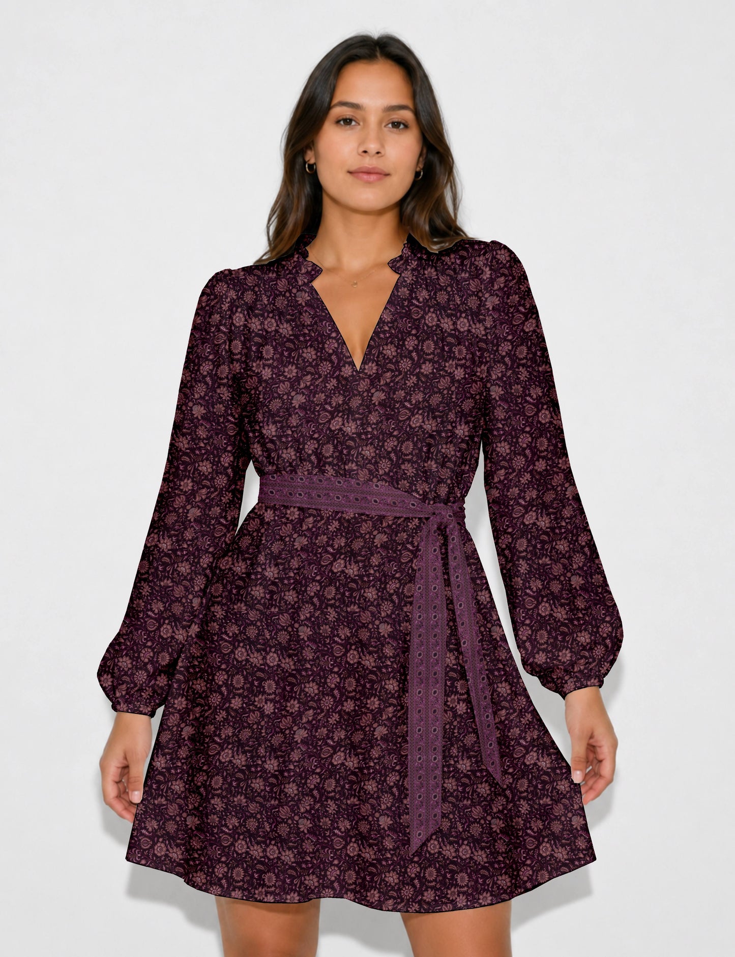 Swing dress with detachable tie belt, gathered ruffle neckline, full-length voluminous sleeves, elastic cuffs, and relaxed A-line silhouette in an above-knee length.