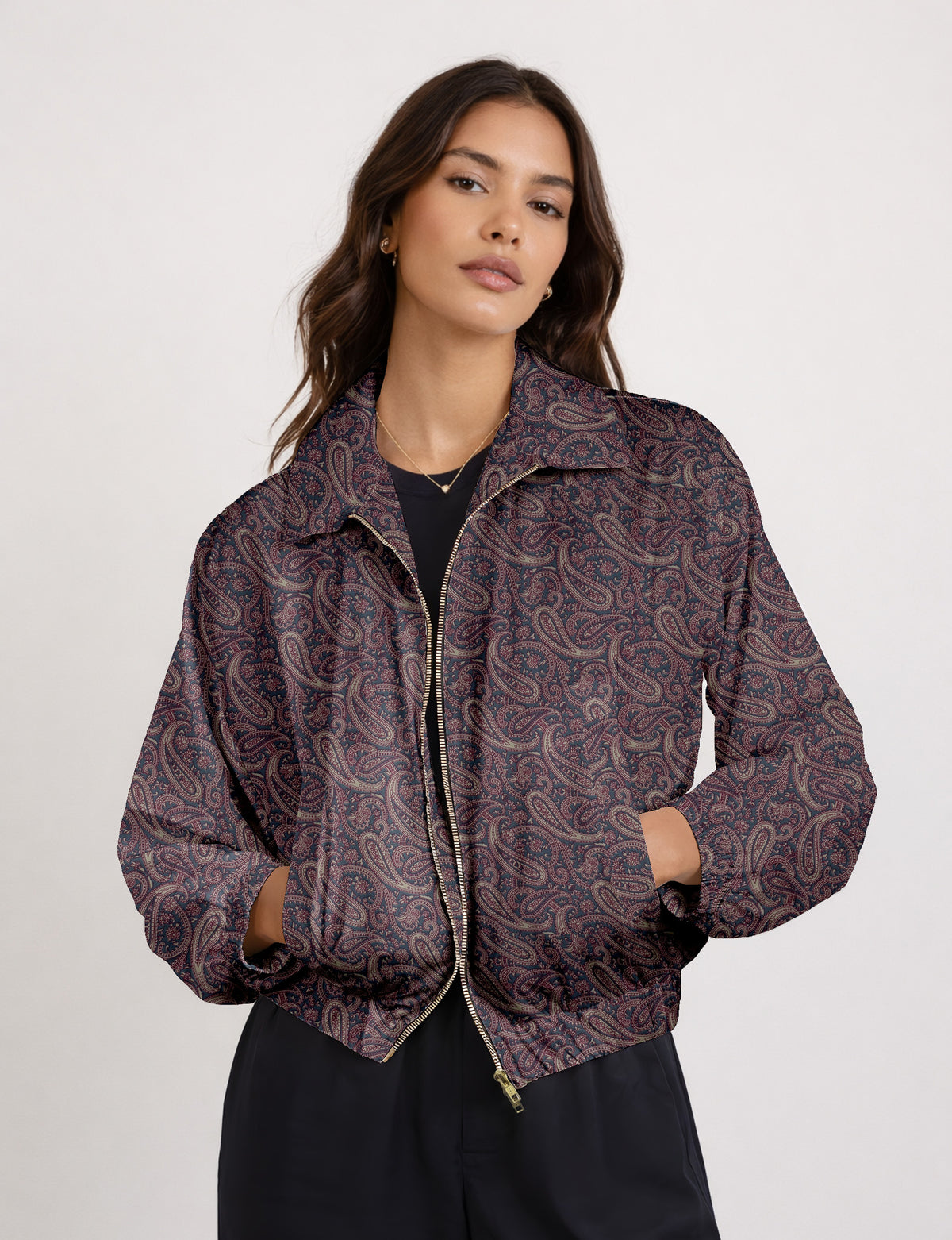 Brown floral bomber jacket with front zipper, elastic cuffs and hem, hanging on white hanger, red floral inner lining visible