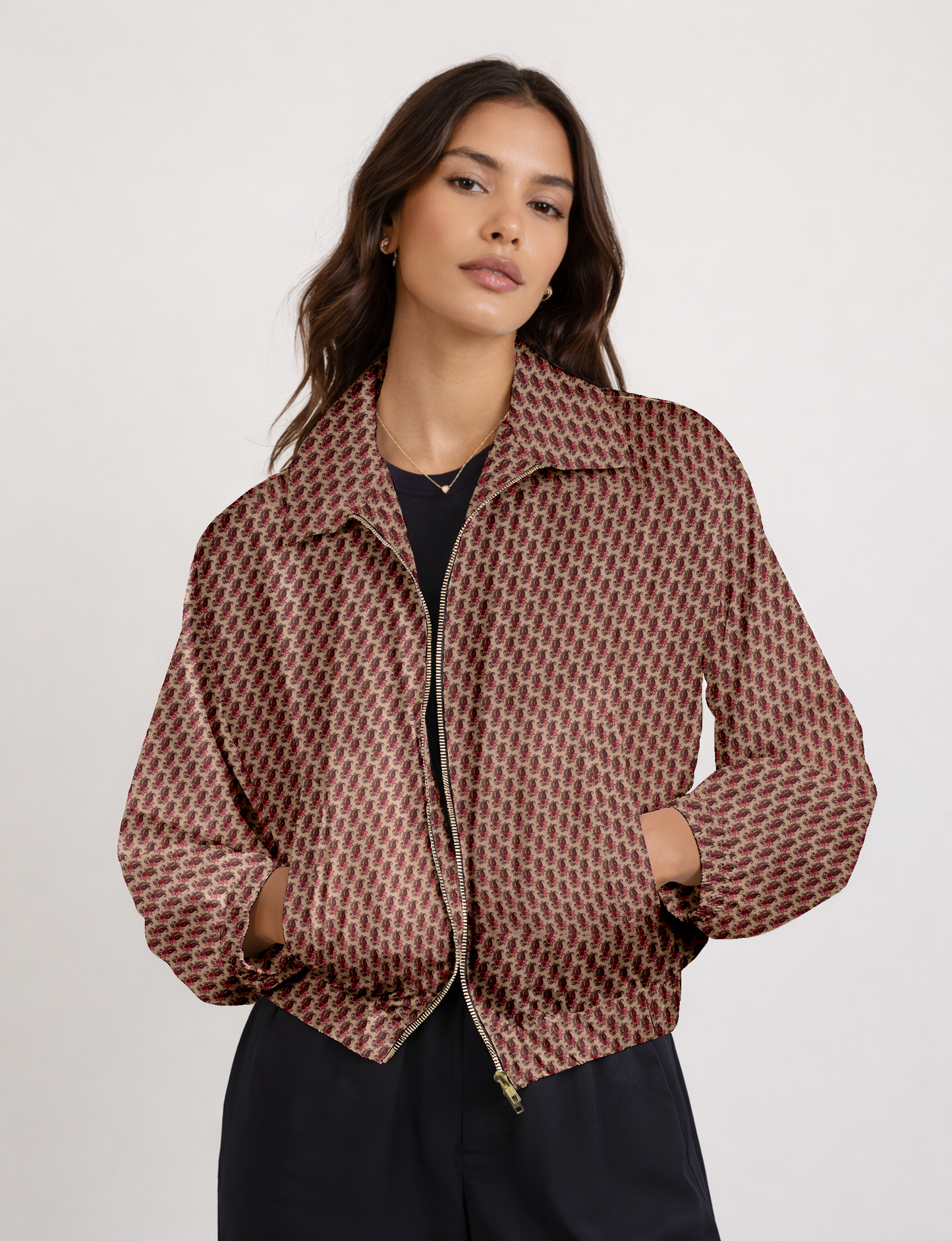 Women's cropped bomber jacket with twin metallic front zippers, welt pockets, elasticated hem and cuffs, and contrast sari print lining.