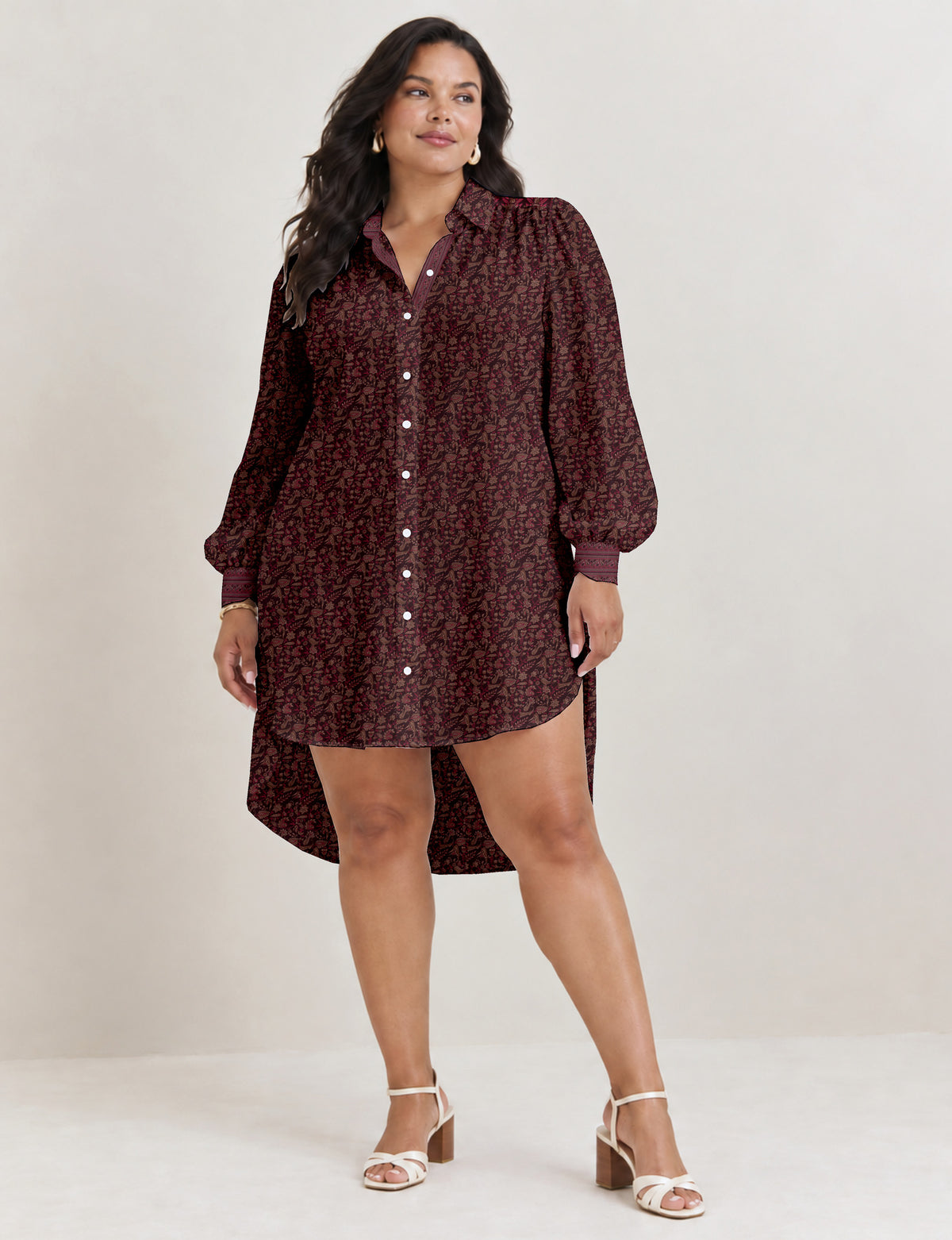 High low shirt with a relaxed fit, button-down front, classic collar, gathered shoulders and full-length blouson sleeves.