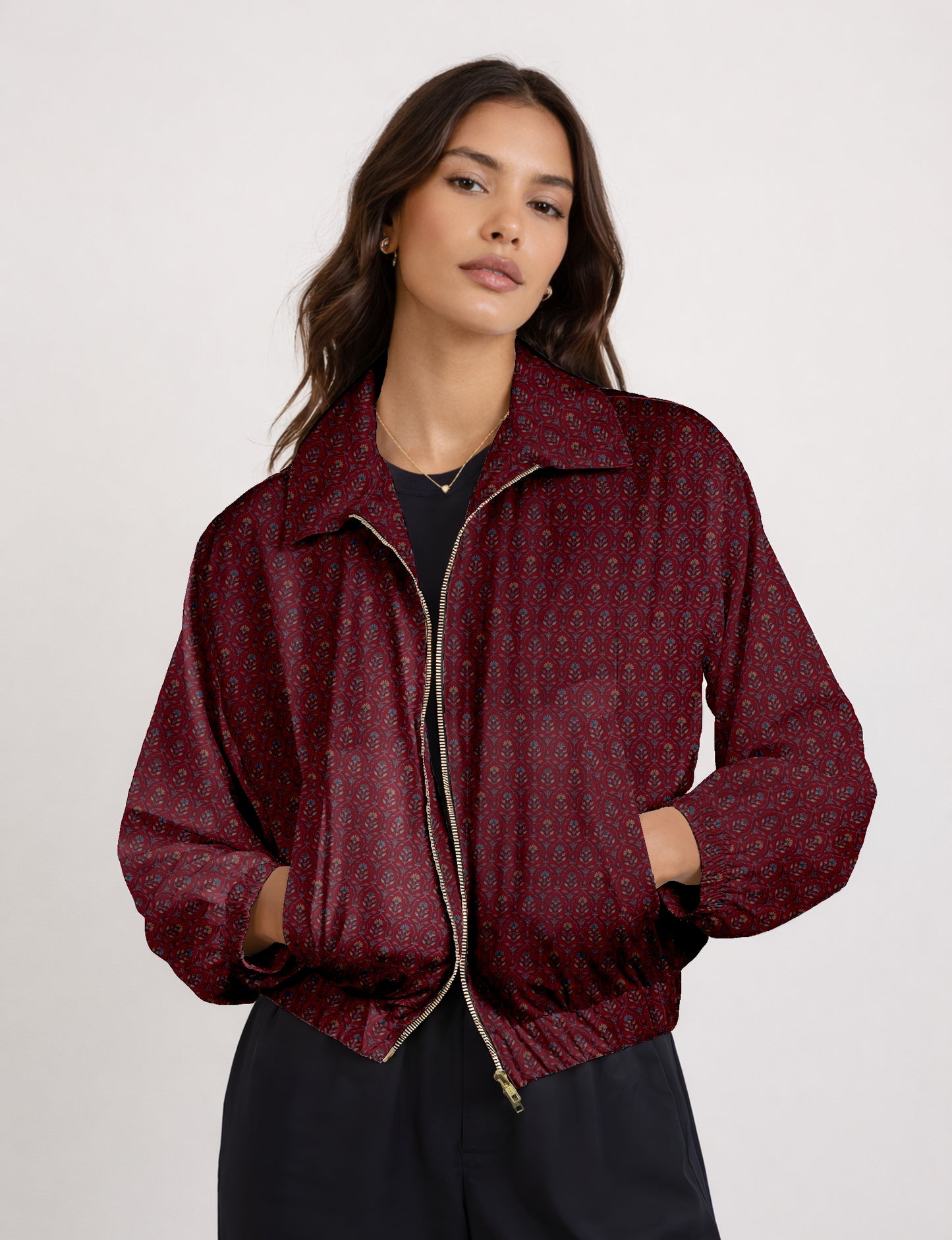 Women's cropped bomber jacket with twin metallic front zippers, welt pockets, elasticated hem and cuffs, and contrast sari print lining.