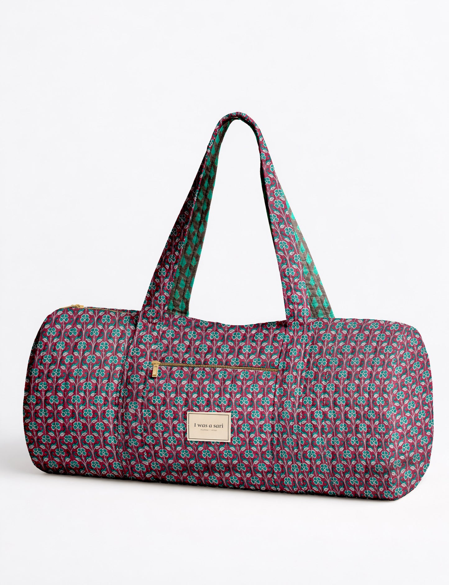 Brown paisley quilted bowling bag with dual handles, front zipper pocket, and "I was a sari" label on front side