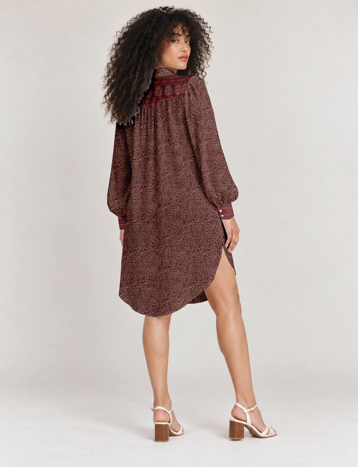 High low shirt with a relaxed fit, button-down front, classic collar, gathered shoulders and full-length blouson sleeves.