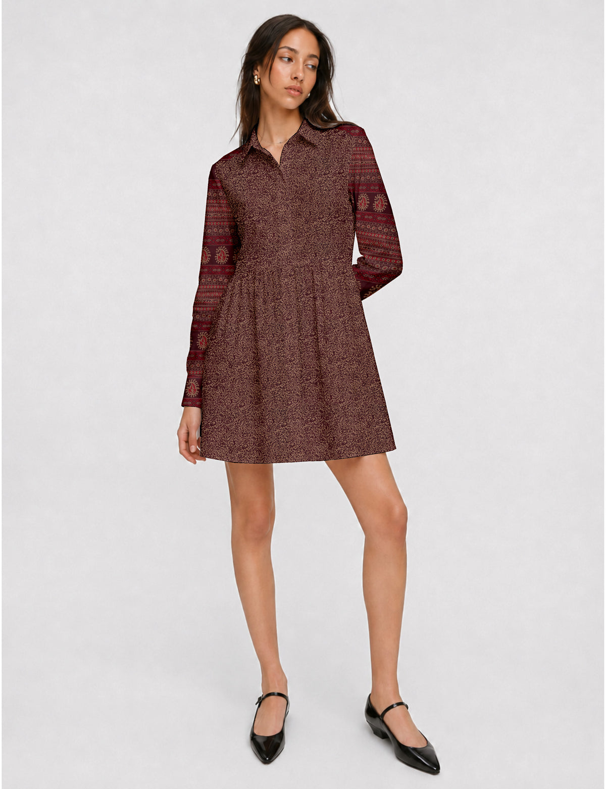 Short shirt dress with a relaxed A-line silhouette, point collar, partial button placket, gathered waist, side pockets, and full-length cuffed sleeves.