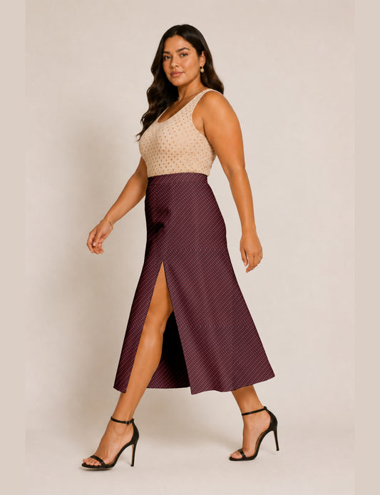 Woman wearing a yellow and black micro patterned A-line skirt with front slit, paired with beige sleeveless top and black