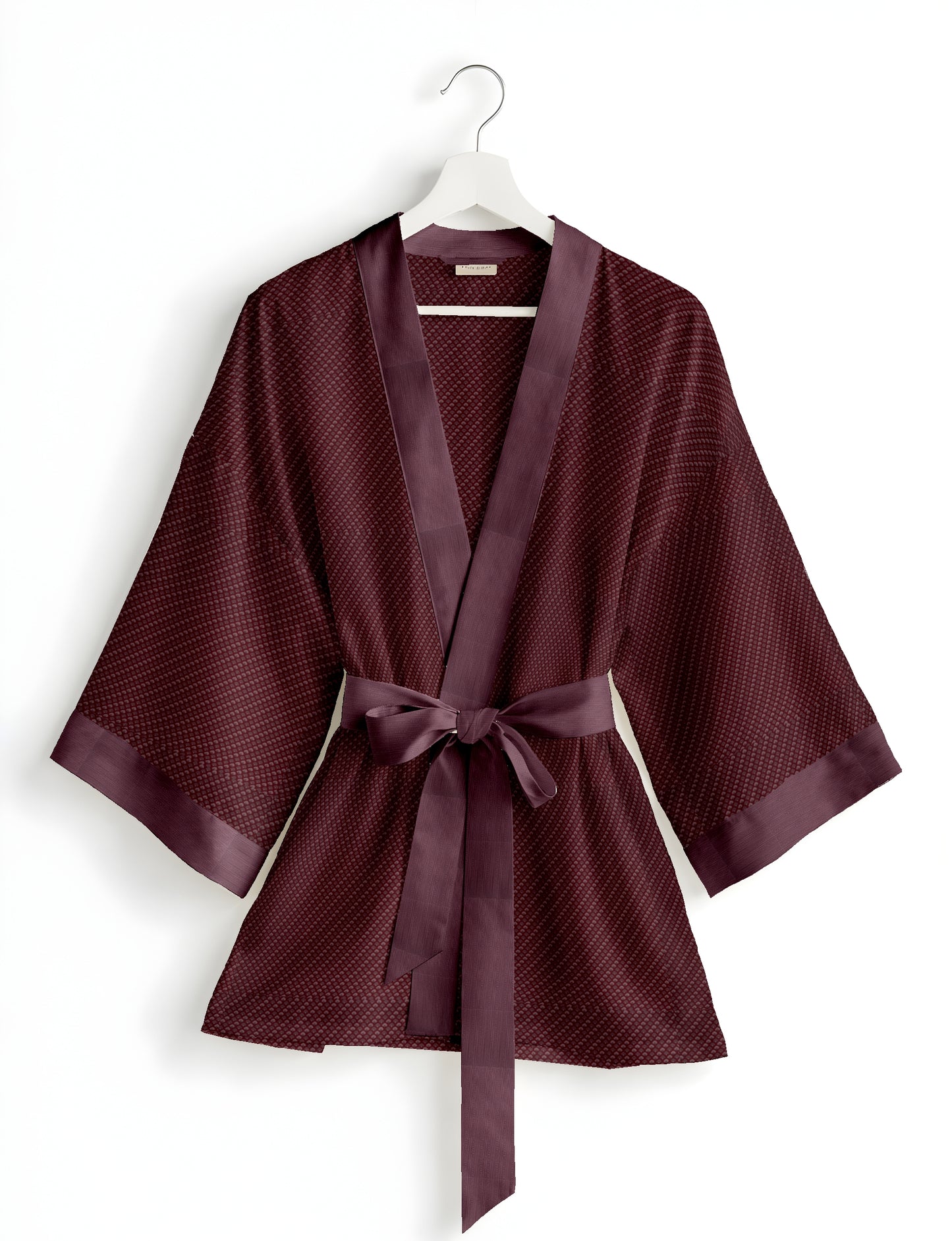 Short kimono robe with wrap front, V-neckline, wide sleeves, waist tie, and concealed skort detail.