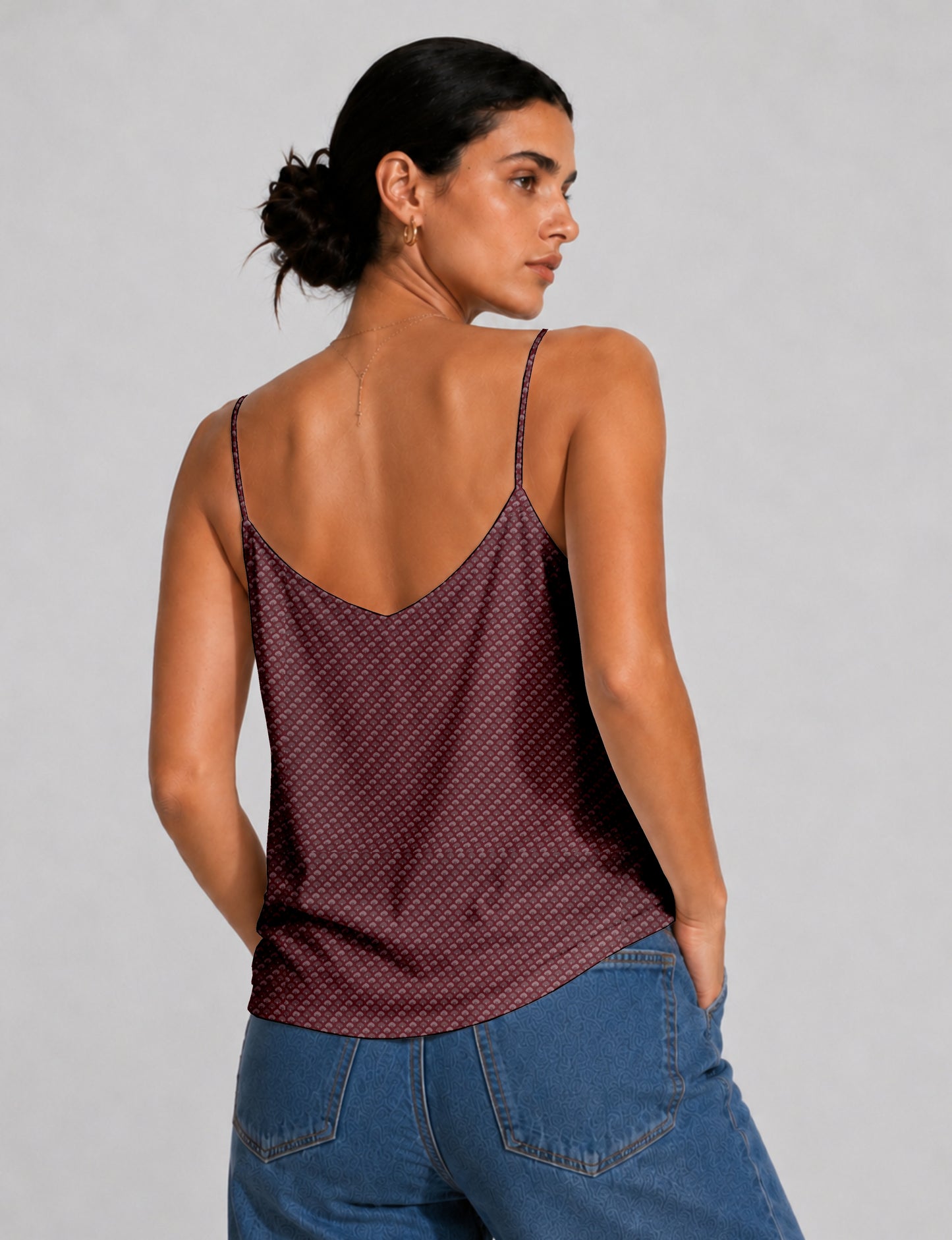 Women's sleeveless slip top with a relaxed straight fit, soft V-neckline, deep V-back, and delicate spaghetti straps.