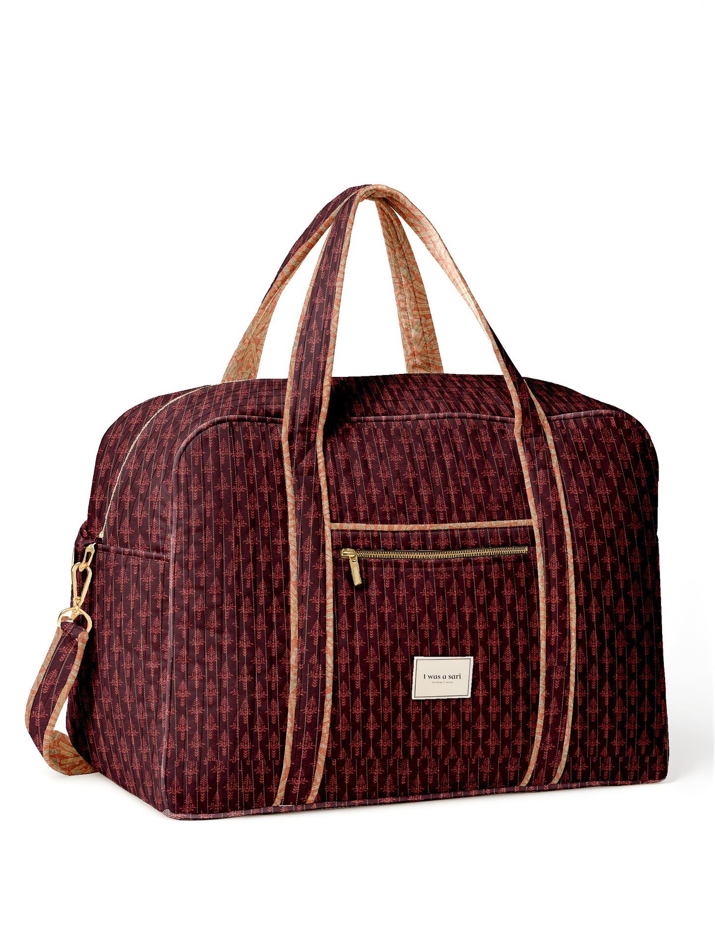 Quilted travel duffle bag with spacious main compartment and zip closure
Stylish quilted duffle bag with dual handles and shoulder strap
Quilted gym and travel bag for everyday use and short trips
I was a Sari quilted duffle bag front view showing structured design
Quilted duffle bag side view with detachable shoulder strap
Open quilted duffle bag showing large storage space inside