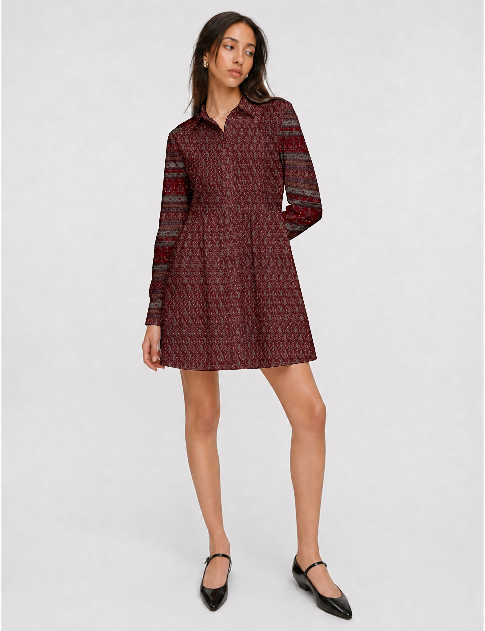 Short shirt dress with a relaxed A-line silhouette, point collar, partial button placket, gathered waist, side pockets, and full-length cuffed sleeves.