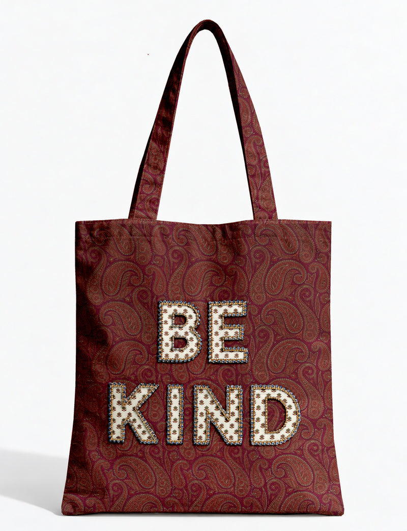 Be Kind tote bag with contrast sari fabric appliqué lettering, double shoulder straps, and front slip pocket.