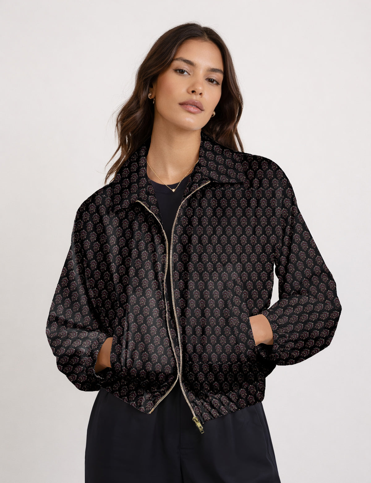 Woman wearing a yellow floral bomber jacket with front zipper, elastic cuffs, and side pockets, shown from front view