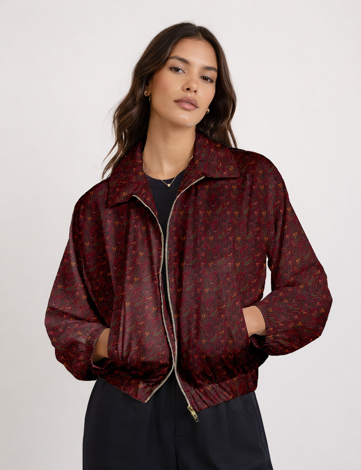 Woman wearing a yellow floral bomber jacket with front zipper, elastic cuffs, and side pockets, shown from front view