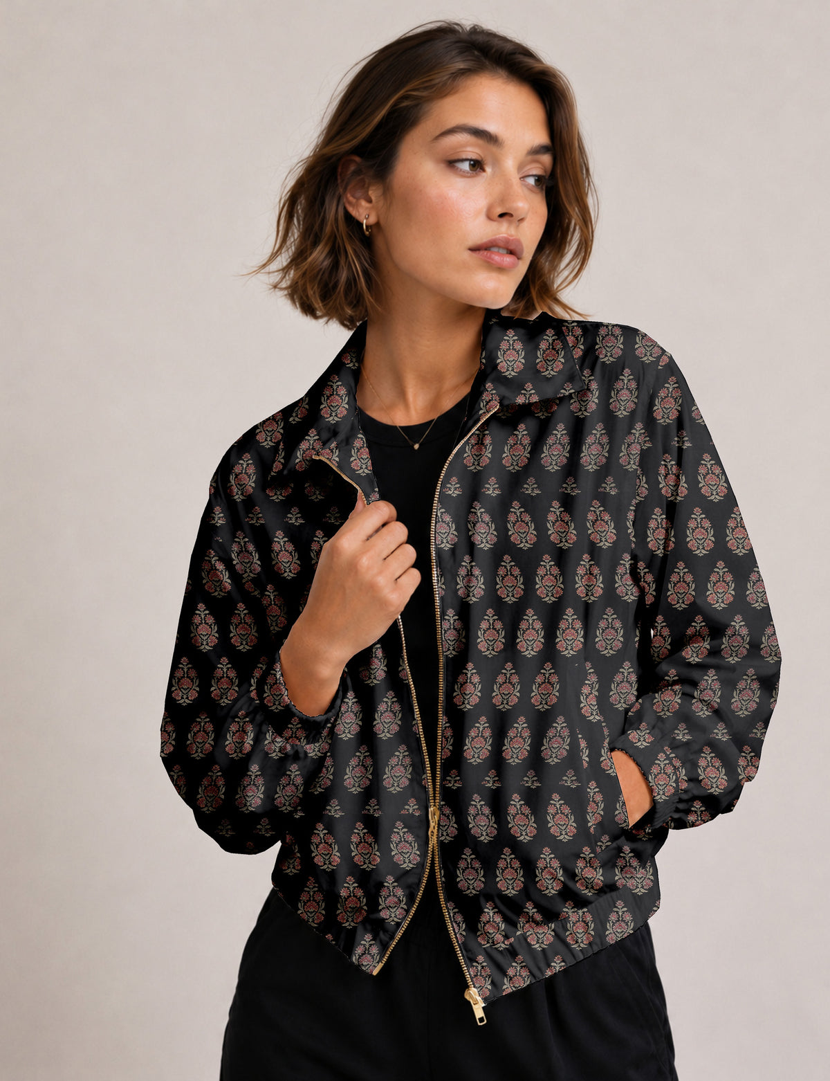 Woman wearing a yellow floral bomber jacket with front zipper, elastic cuffs, and side pockets, shown from front view