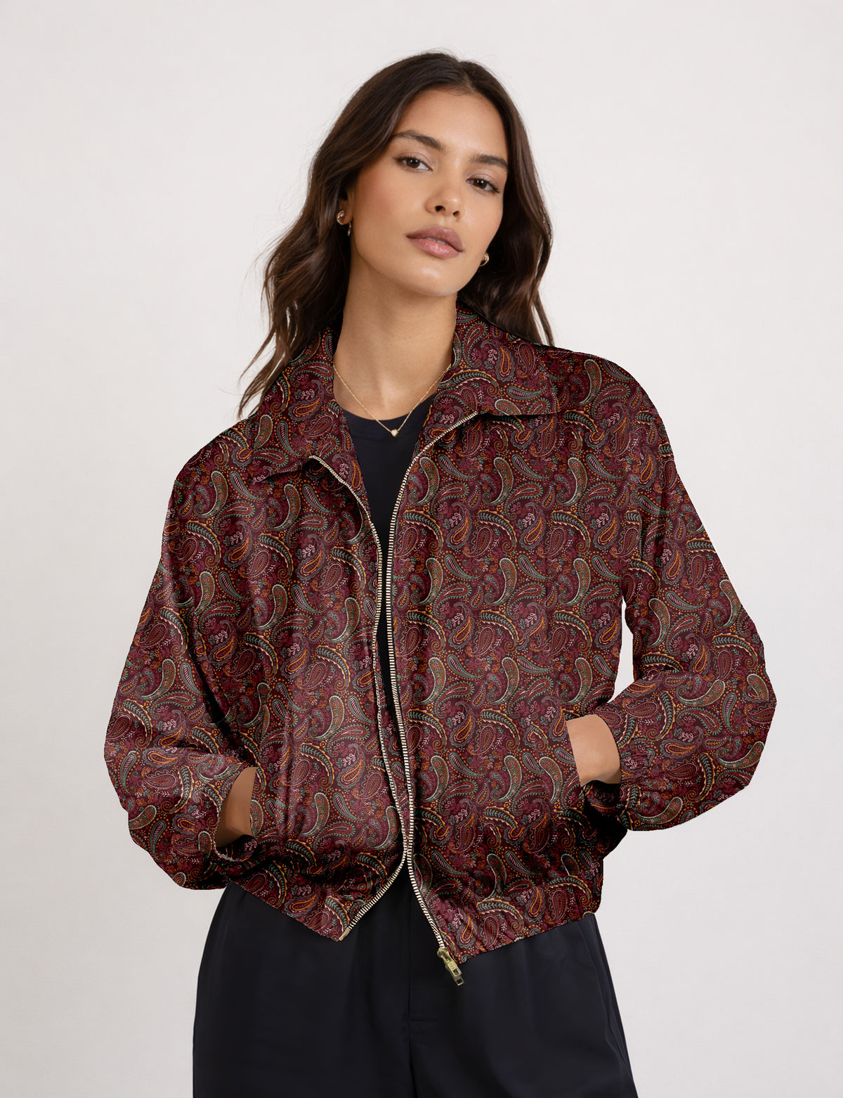 Brown floral bomber jacket with front zipper, elastic cuffs and hem, hanging on white hanger, red floral inner lining visible
