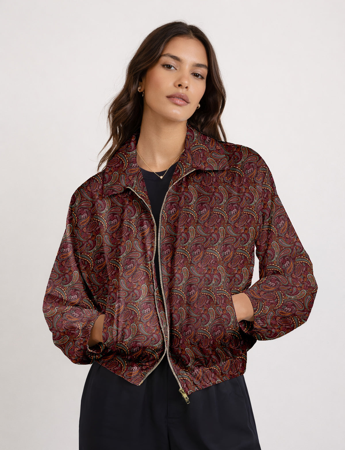 Brown floral bomber jacket with front zipper, elastic cuffs and hem, hanging on white hanger, red floral inner lining visible
