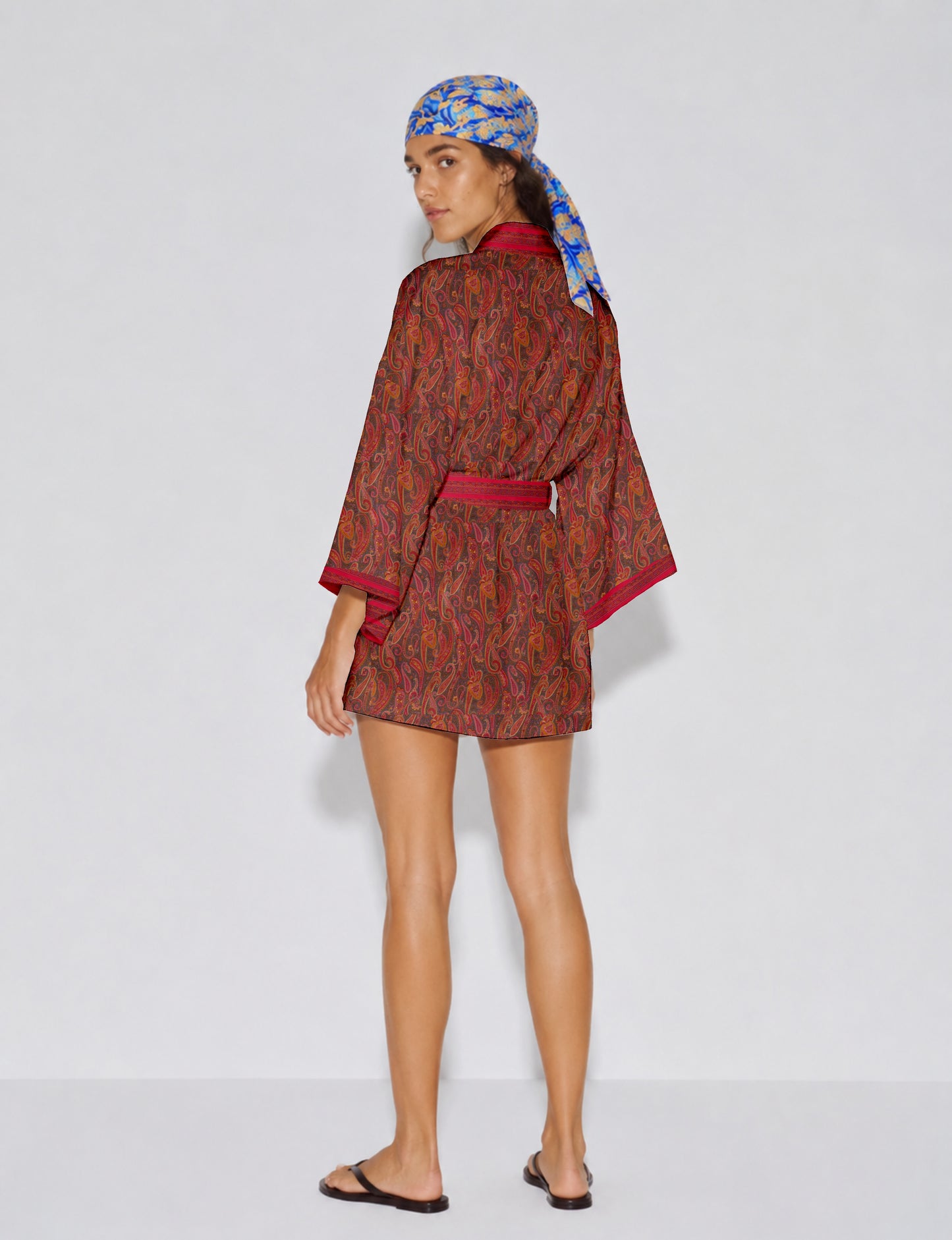 Short kimono robe with wrap front, V-neckline, wide sleeves, waist tie, and concealed skort detail.