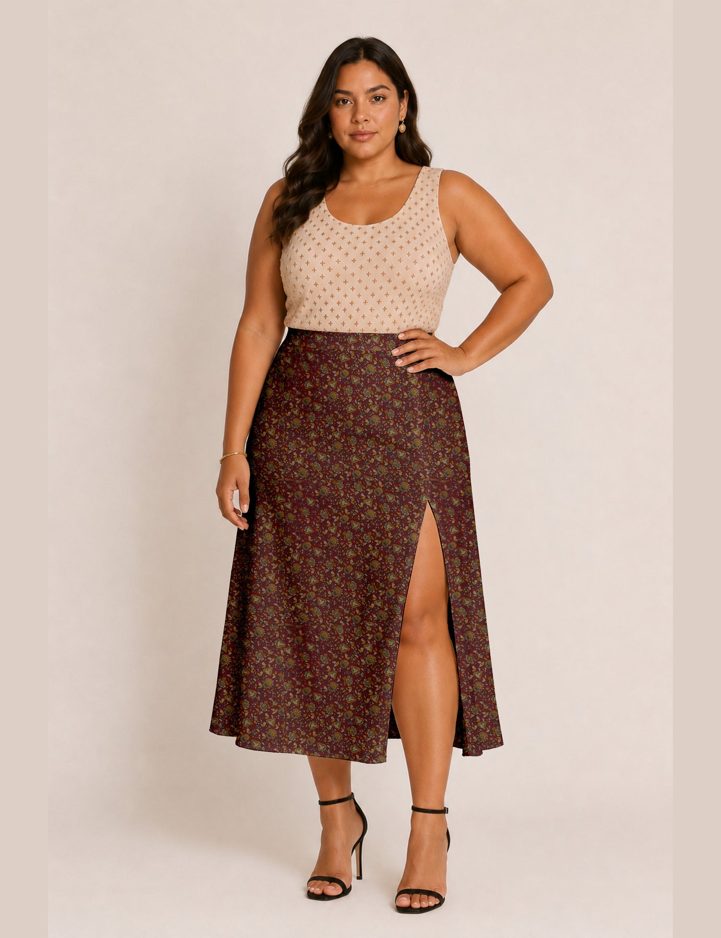 Woman wearing a yellow and black micro patterned A-line skirt with front slit, paired with beige sleeveless top and black