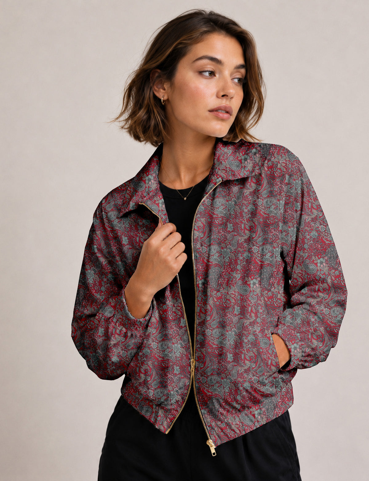 Woman wearing a yellow floral bomber jacket with front zipper, elastic cuffs, and side pockets, shown from front view