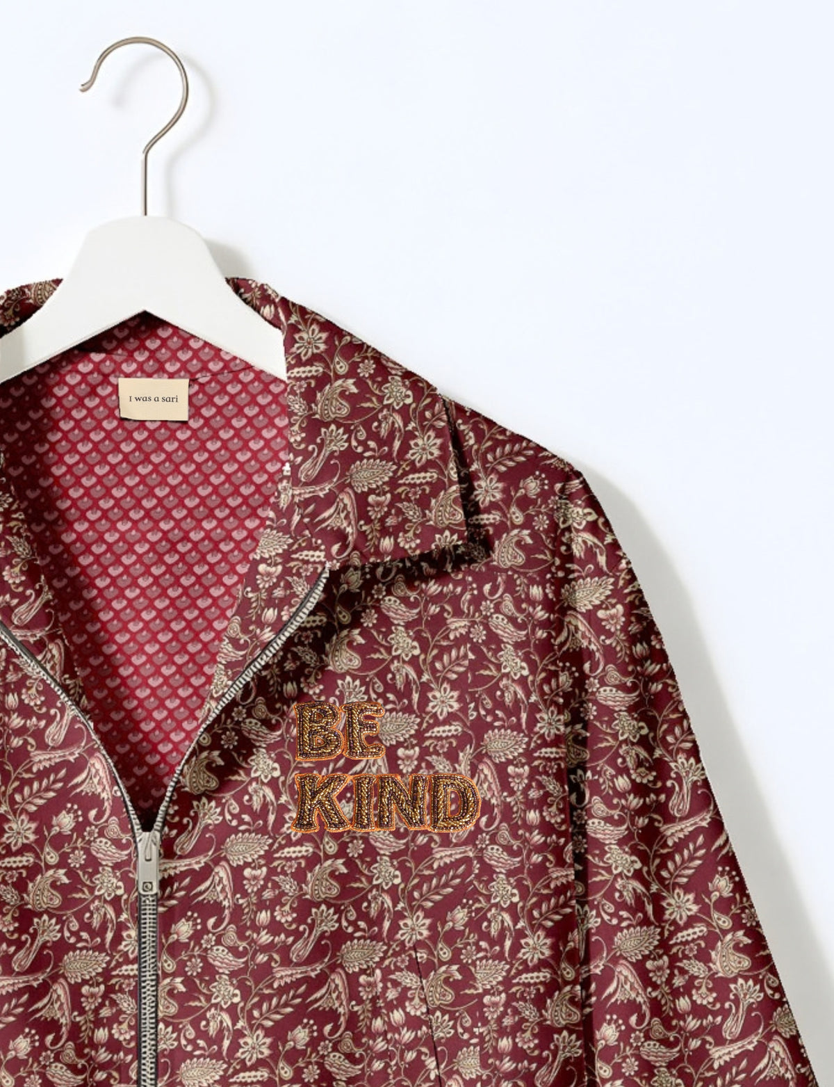 BE KIND Bomber jacket made from upcycled sari fabric with handcrafted Aari embroidery by female artisans.