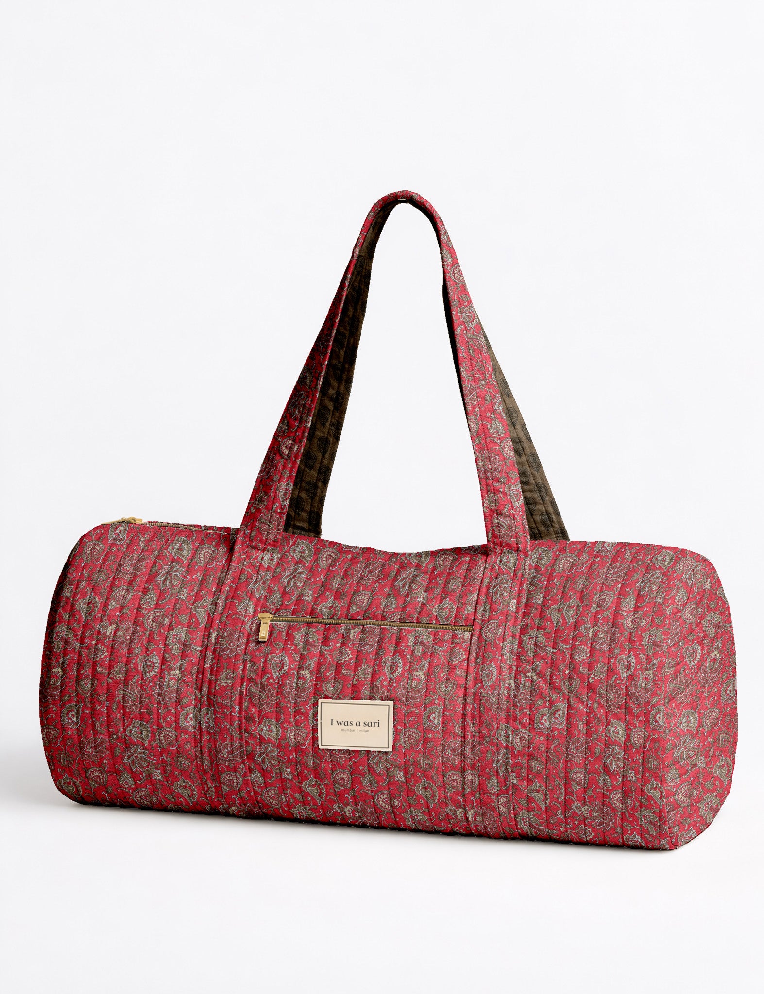 Brown paisley quilted bowling bag with dual handles, front zipper pocket, and "I was a sari" label on front side