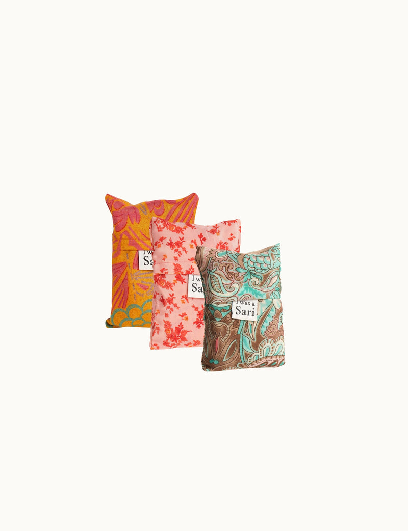 Set of three reusable bags with floral and paisley patterns in orange, pink, and teal, each labeled "I was a Sari"