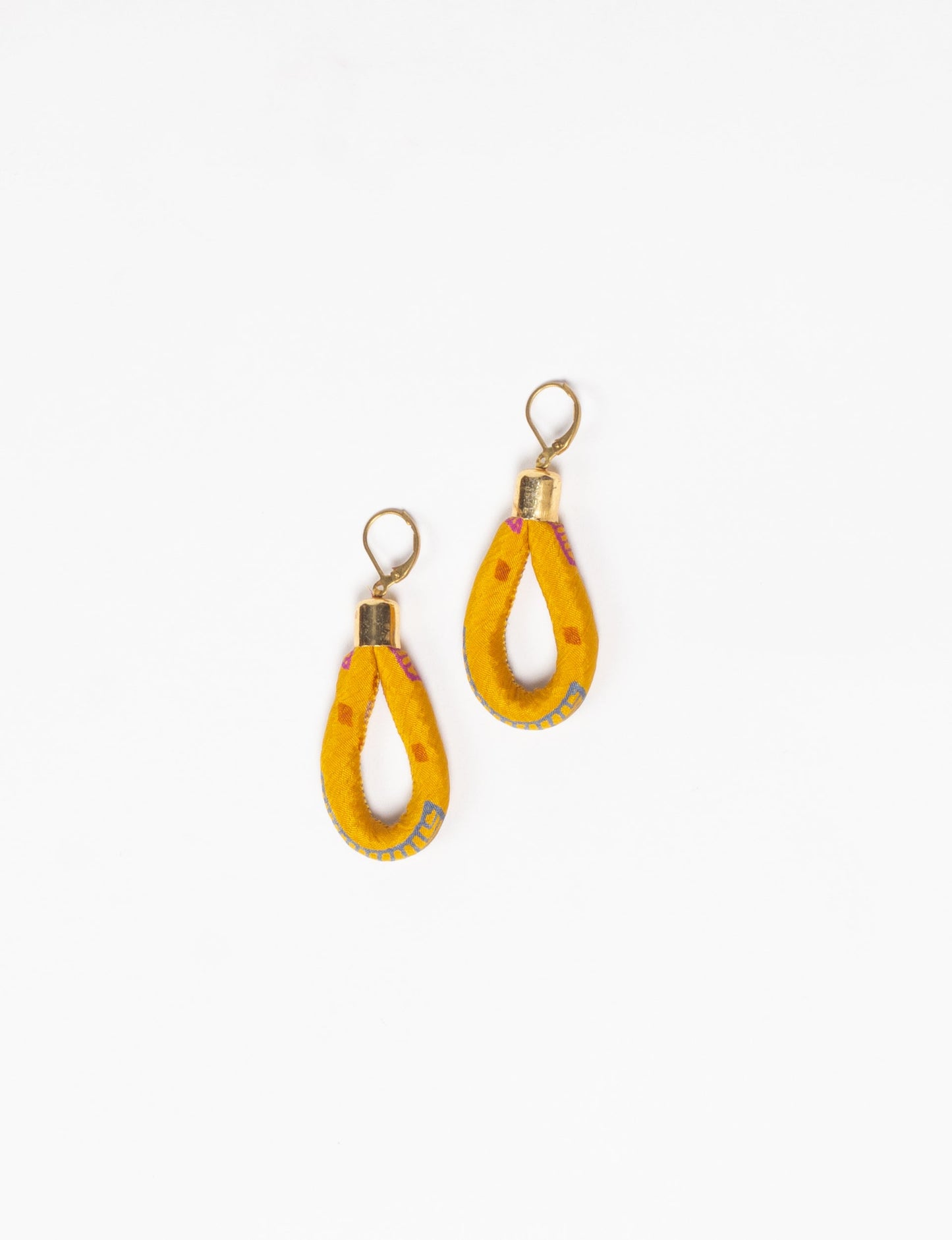 Elevate your style sustainably with our Rope Earrings. Crafted from cotton rope hand-wrapped with pre-loved saris, these earrings are a testament to ethical and green fashion. Make a conscious choice for a brighter, eco-friendly future.