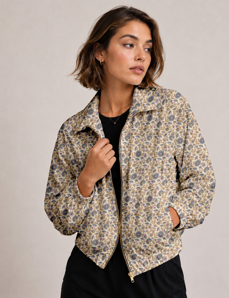Brown floral bomber jacket with front zipper, elastic cuffs and hem, hanging on white hanger, red floral inner lining visible