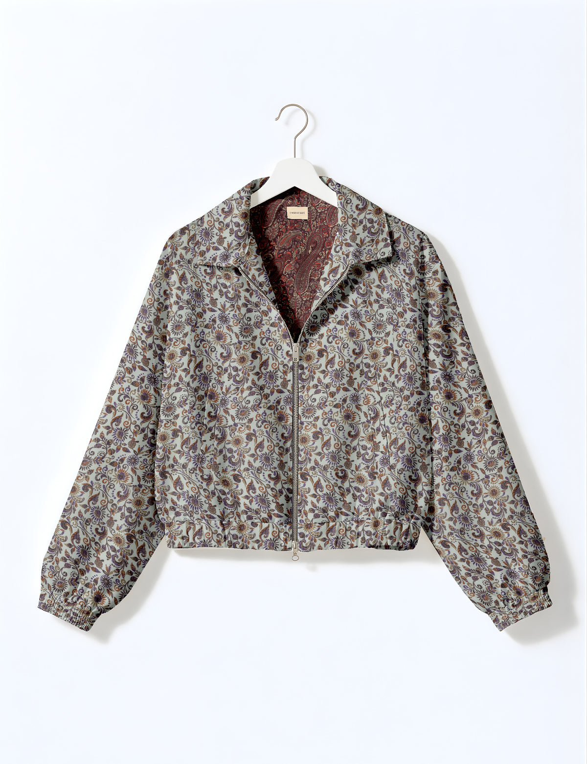 Woman wearing a yellow floral bomber jacket with front zipper, elastic cuffs, and side pockets, shown from front view