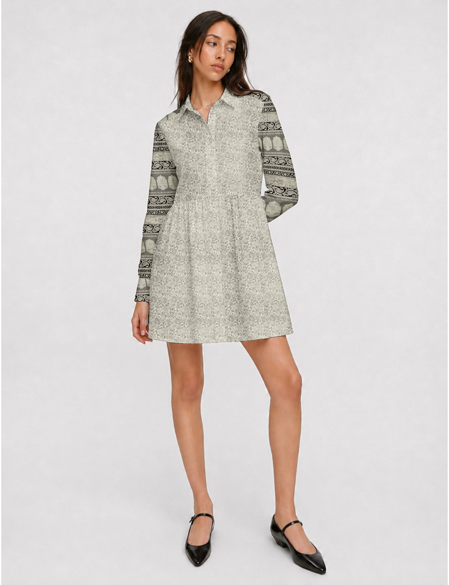 Short shirt dress with a relaxed A-line silhouette, point collar, partial button placket, gathered waist, side pockets, and full-length cuffed sleeves.