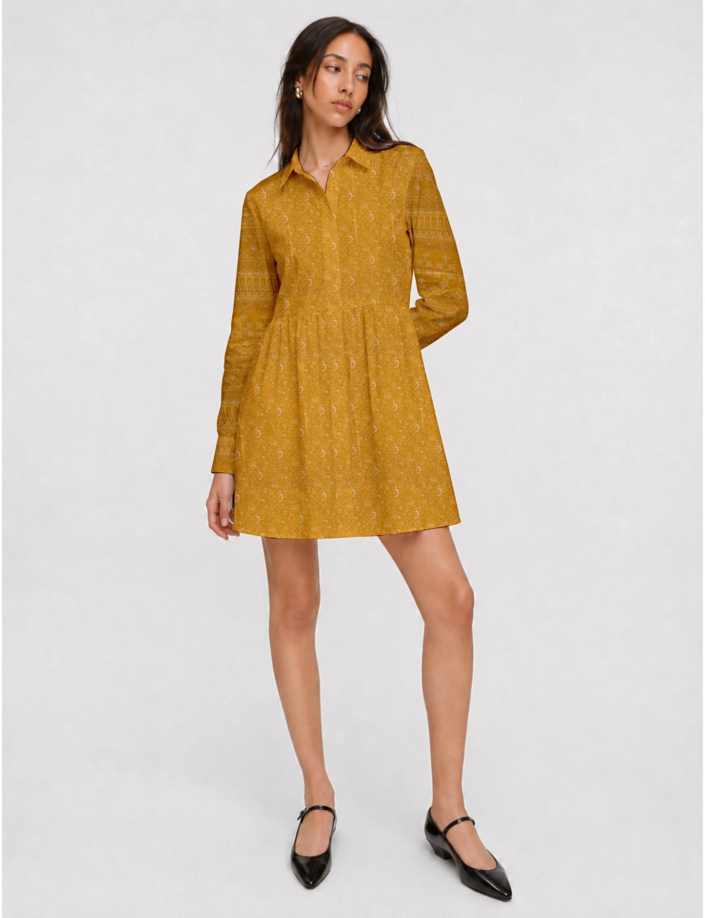 Short shirt dress with a relaxed A-line silhouette, point collar, partial button placket, gathered waist, side pockets, and full-length cuffed sleeves.
