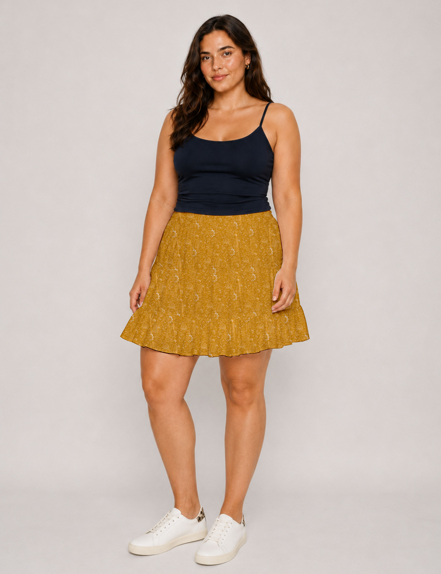 Short tiered skirt with a fitted waistband, knife pleats, softly flared silhouette, side seam pockets, and above-the-knee length.
