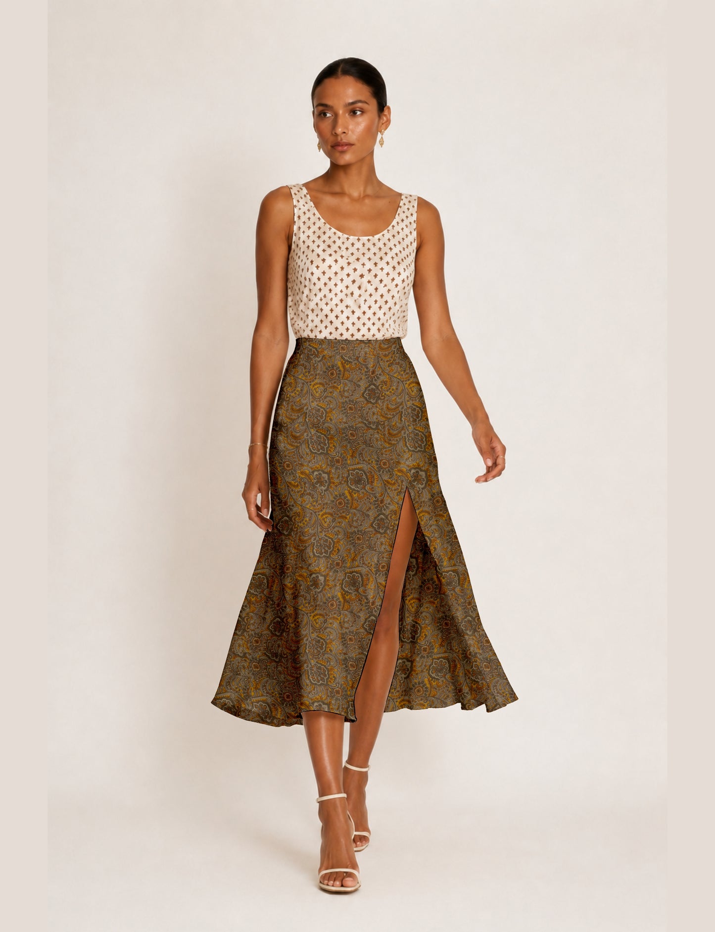 Midi A-line skirt with front slit, fitted waistband, concealed side closure, and below mid-calf length silhouette.