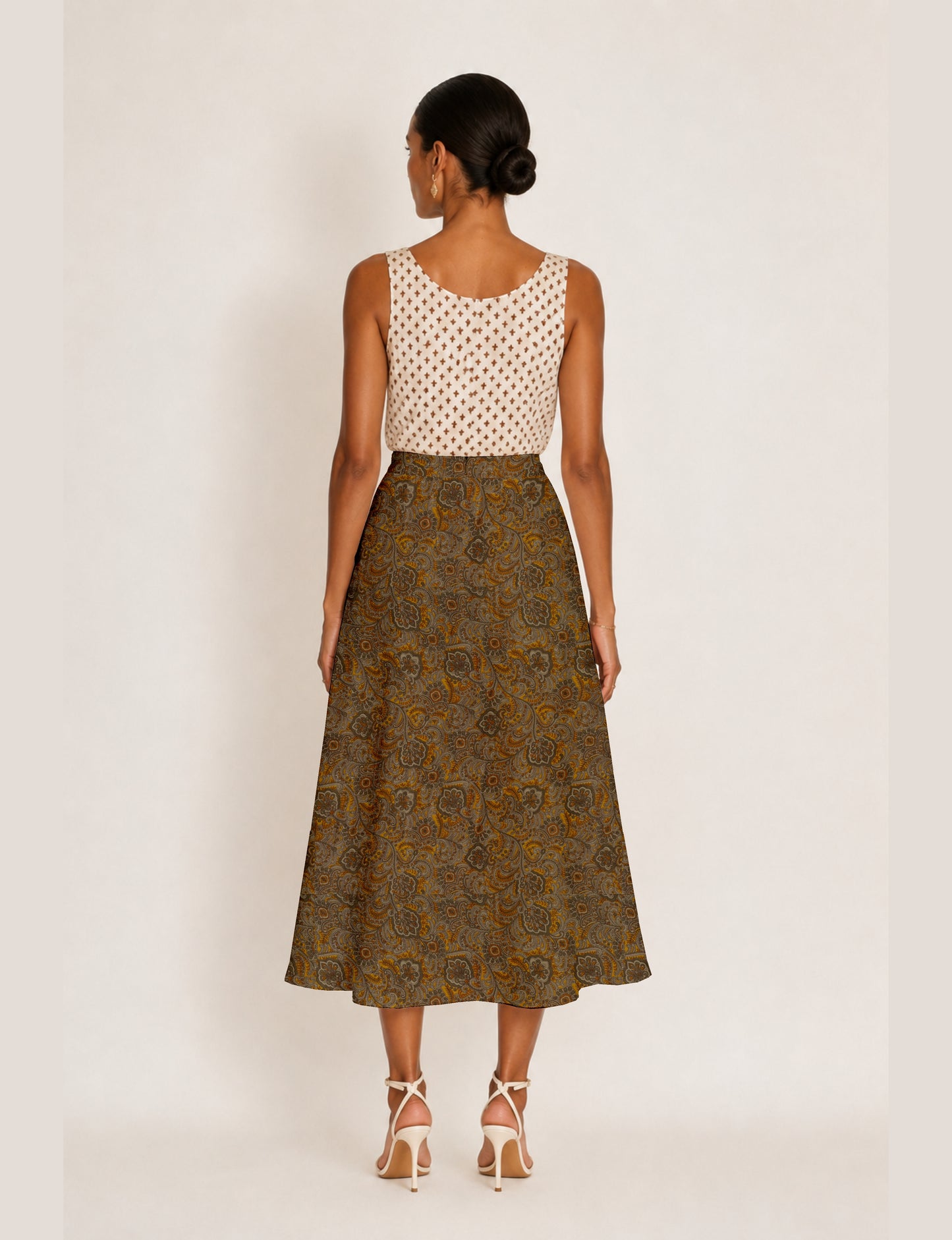 Midi A-line skirt with front slit, fitted waistband, concealed side closure, and below mid-calf length silhouette.