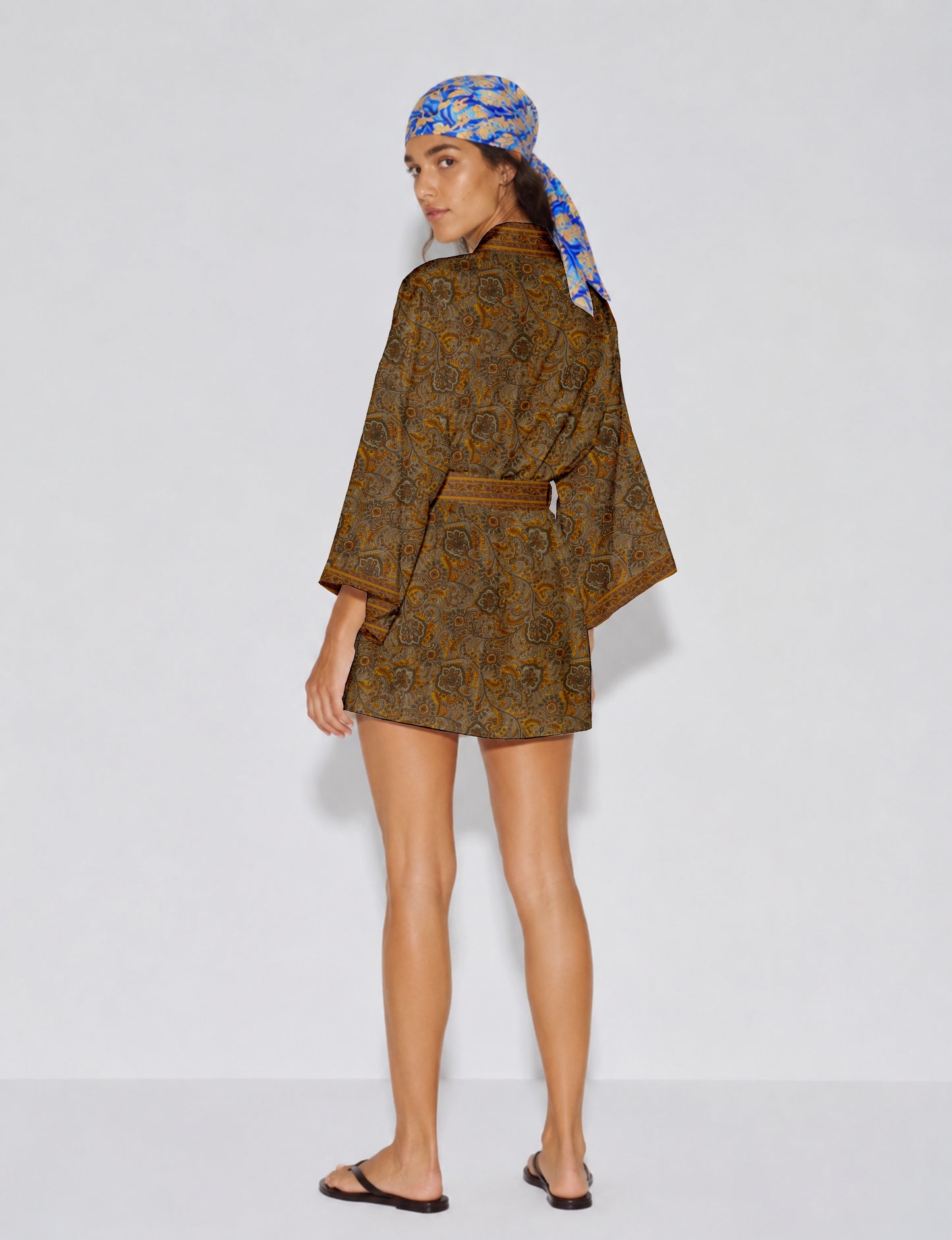 Short kimono robe with wrap front, V-neckline, wide sleeves, waist tie, and concealed skort detail.