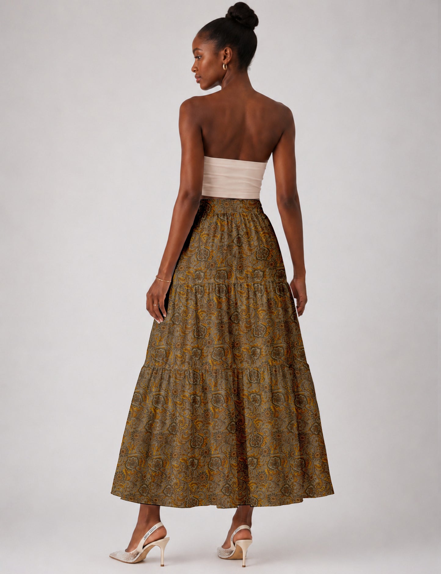 Midi tiered skirt with fitted waistband, soft knife pleats, flared silhouette, side seam pockets, and ankle-length hem