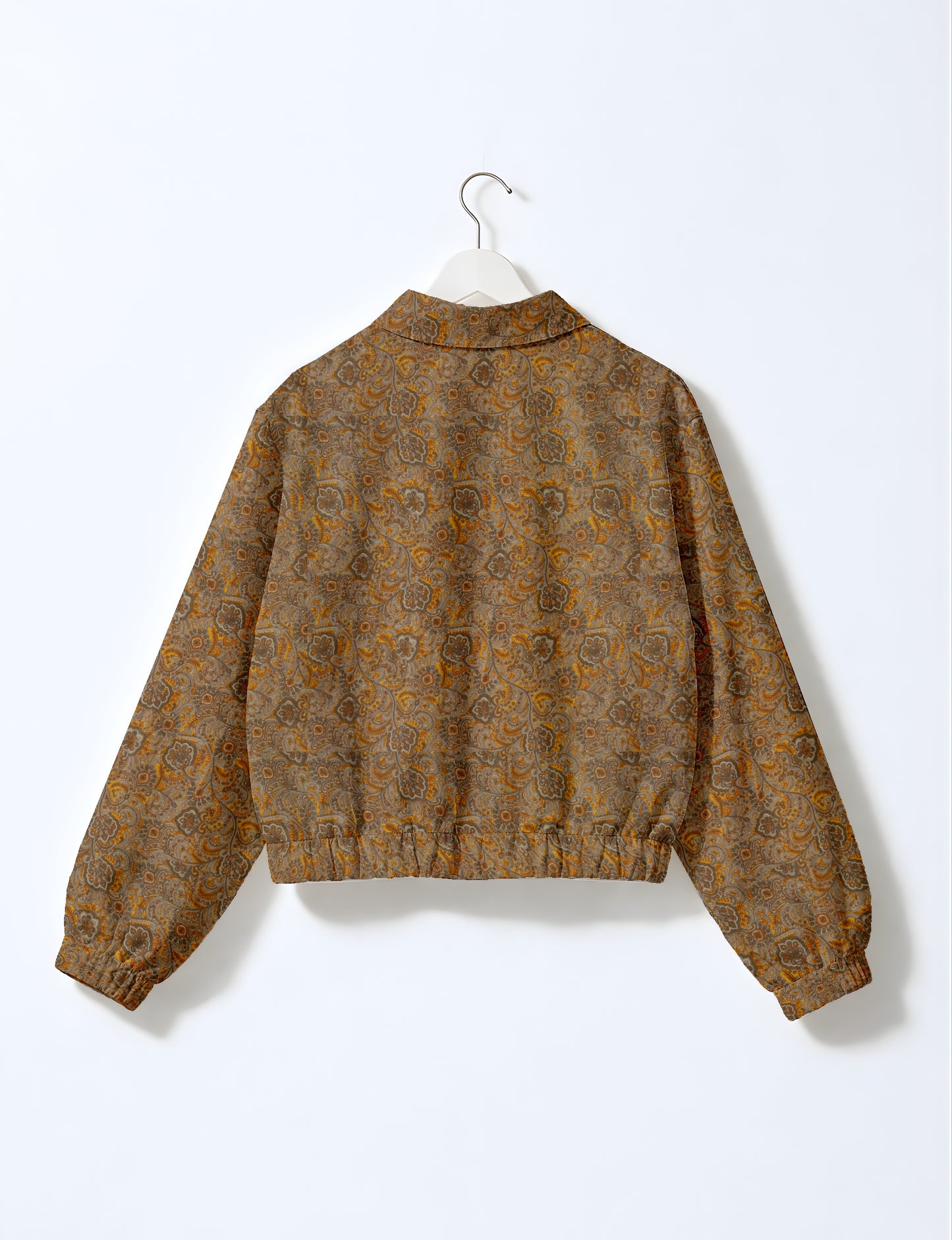 Women's cropped bomber jacket with twin metallic front zippers, welt pockets, elasticated hem and cuffs, and contrast sari print lining.