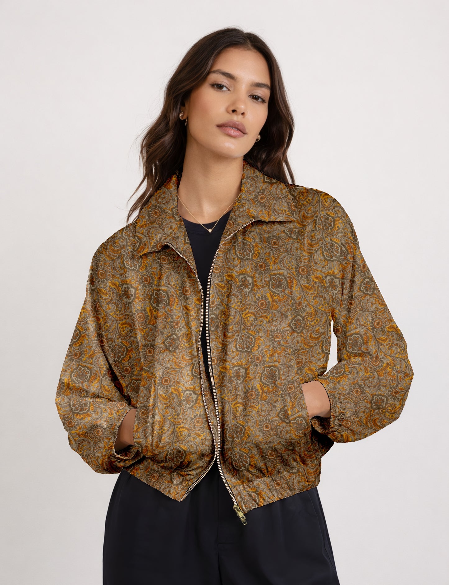 Women's cropped bomber jacket with twin metallic front zippers, welt pockets, elasticated hem and cuffs, and contrast sari print lining.