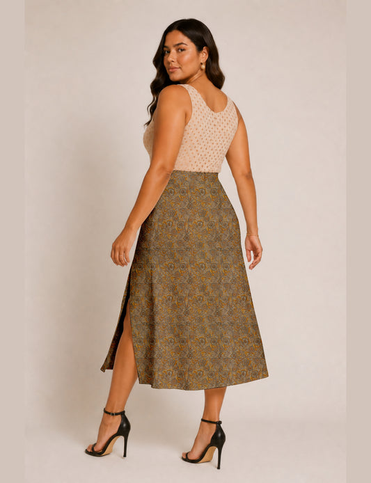 Woman wearing a yellow and black micro patterned A-line skirt with front slit, paired with beige sleeveless top and black