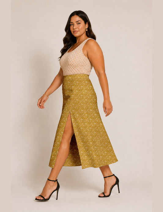 Woman wearing a yellow and black micro patterned A-line skirt with front slit, paired with beige sleeveless top and black