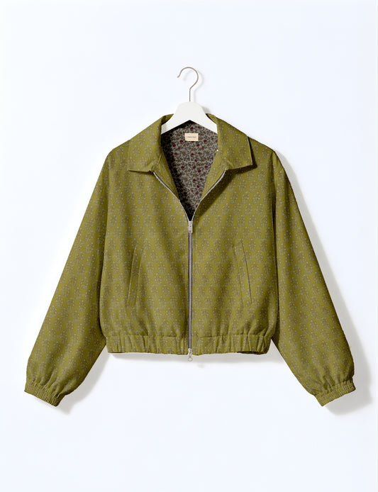 Women's cropped bomber jacket with twin metallic front zippers, welt pockets, elasticated hem and cuffs, and contrast sari print lining.