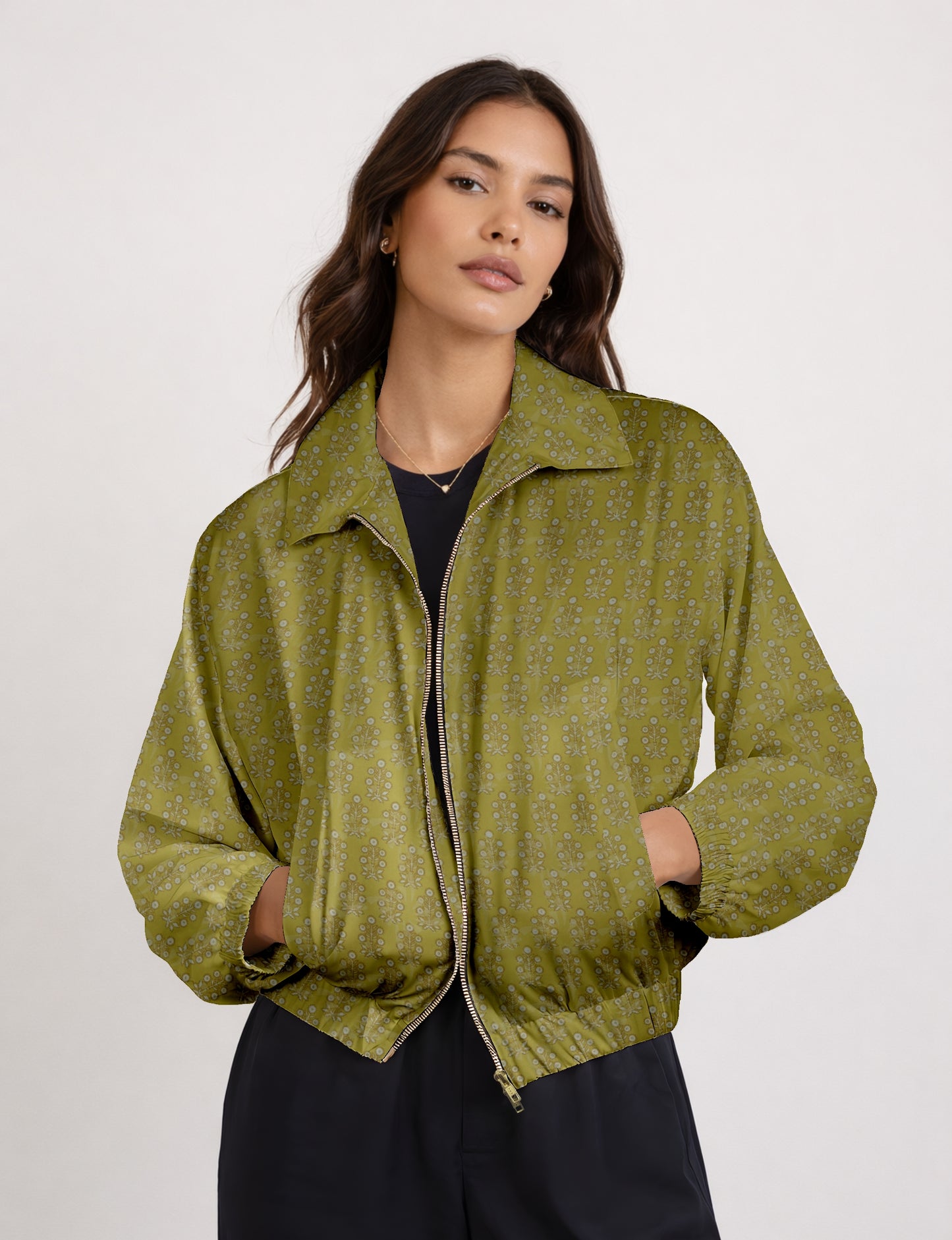 Women's cropped bomber jacket with twin metallic front zippers, welt pockets, elasticated hem and cuffs, and contrast sari print lining.