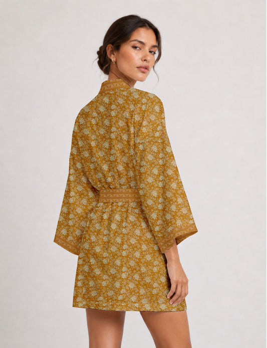 Short kimono robe with wrap front, V-neckline, wide sleeves, waist tie, and concealed skort detail.