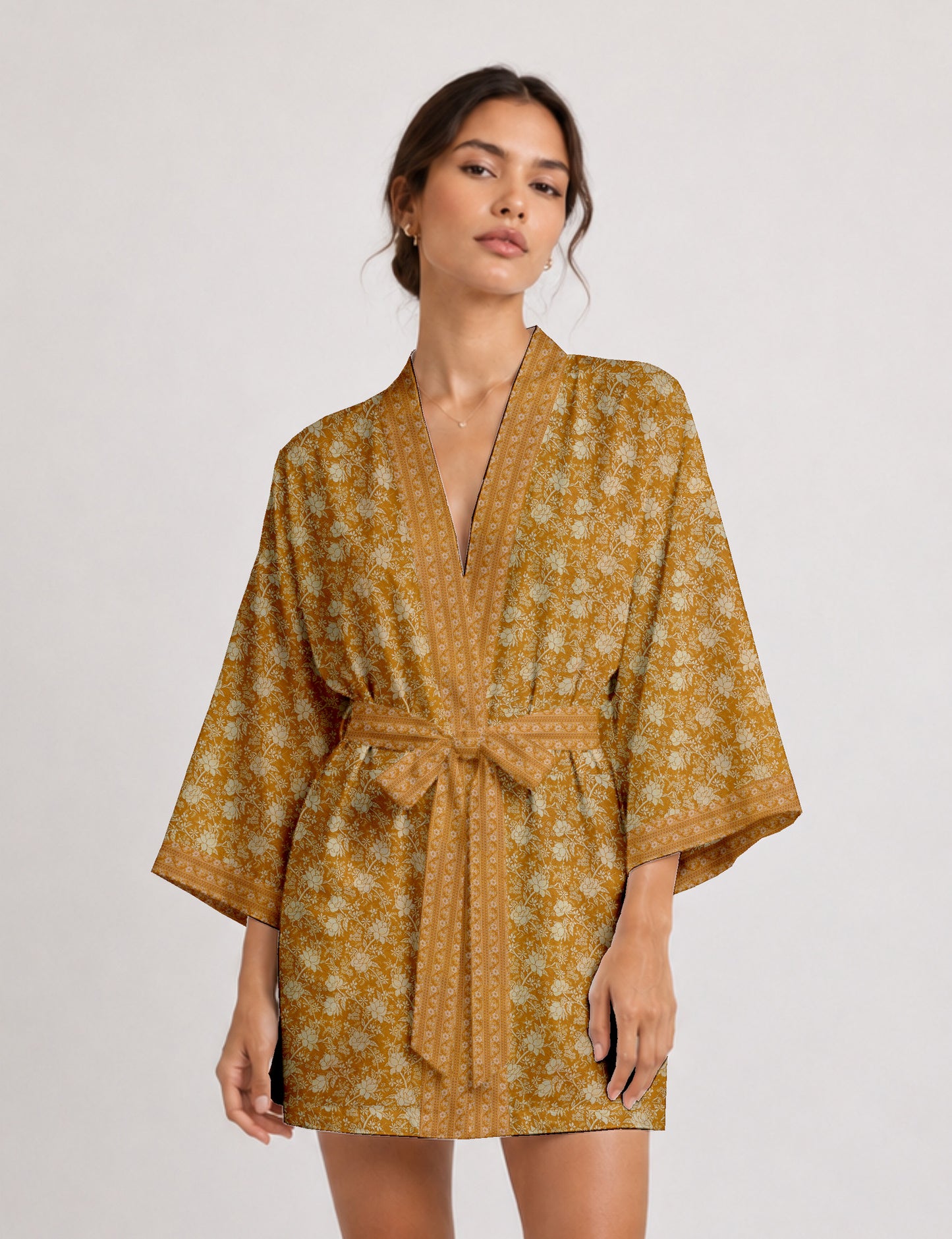 Short kimono robe with wrap front, V-neckline, wide sleeves, waist tie, and concealed skort detail.
