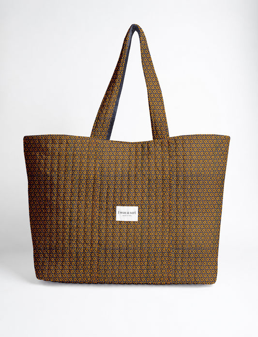 Large quilted beach bag with spacious rectangular design, reinforced shoulder straps, and open-top construction for everyday use and travel.